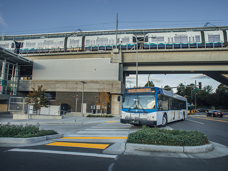 Community Transit bus entering a stop at a light rail station.